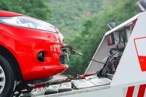 A red car being towed after an accident