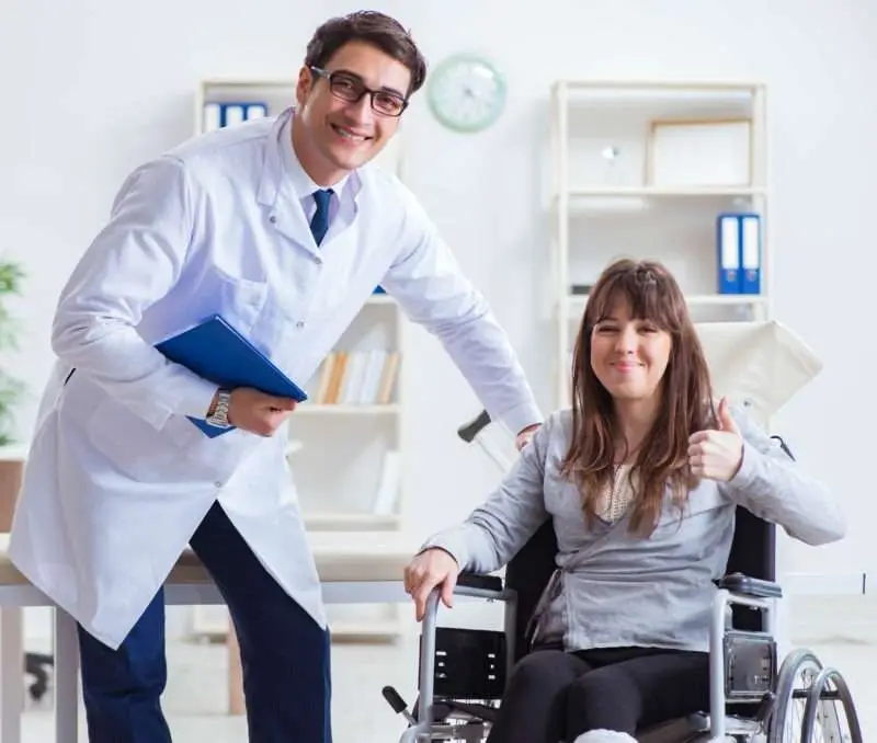 doctor treats injured patient in wheelchair