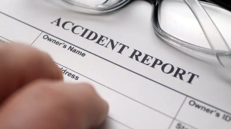 hand on accident report after a car accident to protect rights