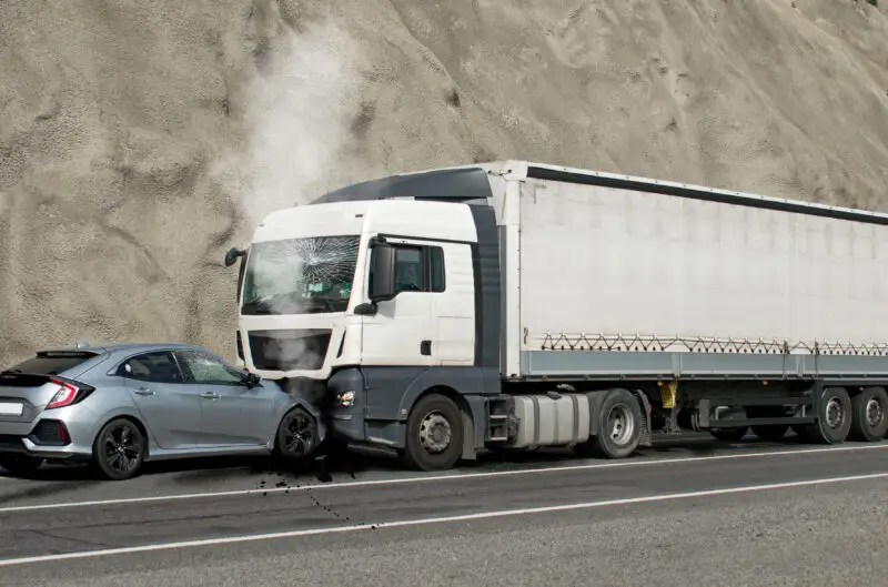A frontal-impact collision between a car and a commercial truck.