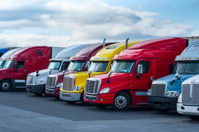 A row of trucks. We’ll help you determine if you can sue a company after a truck accident.