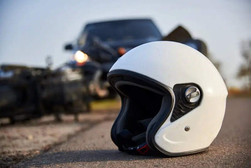 Motorcycle and helmet laying in the road while a Hilton Head motorcycle accident lawyer is contacted following the accident. 