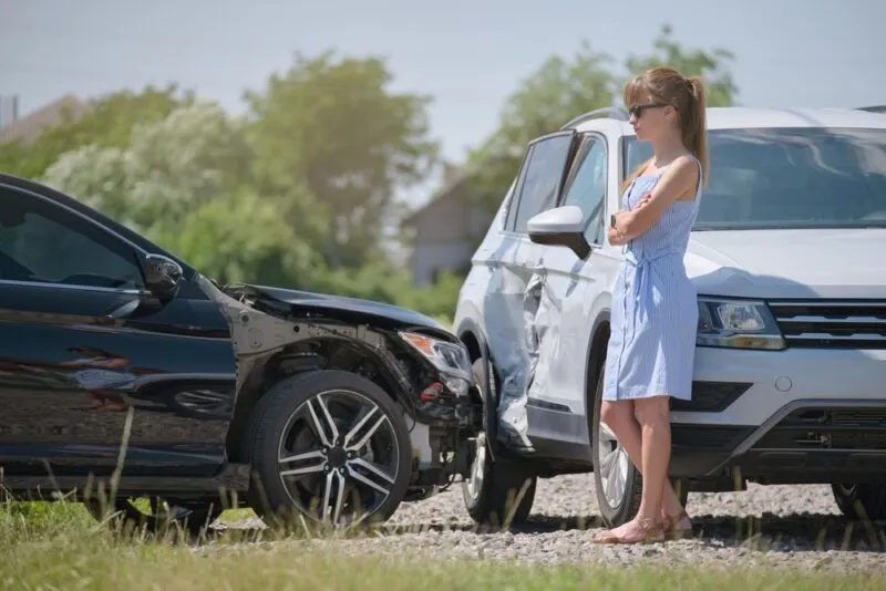 A woman standing by the road after a collision. You can take charge of your future with a Rock Hill car accident lawyer.