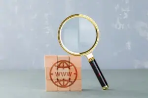 conceptual-internet-search-with-wooden-blocks-with-internet-icon-magnifying-glass-side-view