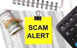 desktop-there-are-reports-notepads-calculator-cash-yellow-sticker-with-text-scam-alert-business-concept
