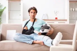 man-sitting-on-his-couch-after-a-motorcycle-wreck