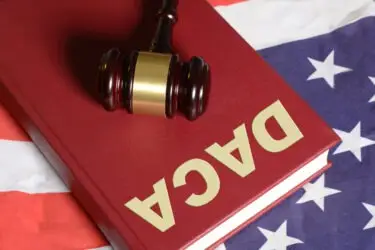 an-american-flag-a-gavel-and-a-daca-book
