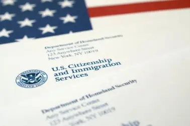 USCIS letterhead with an American flag in the background. Discover more about the USCIS review process for your case.