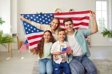 American family celebrating. How do you sponsor a sibling to get their green card?