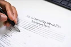 hand filling out social security form