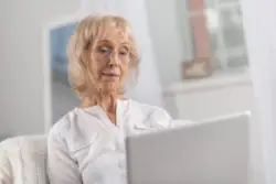 sad older woman using computer