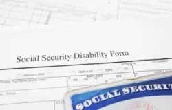 a blank Social Security disability form and the top of a Social Security card