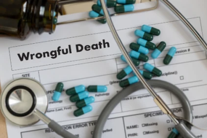 Wrongful death documents with a stethoscope and medication.