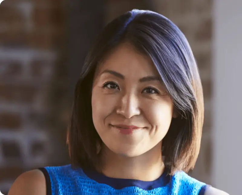 An Asian woman smiles at the camera. She is visible from the shoulders up. Rockpoint Legal Funding provides pre-settlement funding to plaintiffs in personal injury lawsuits.