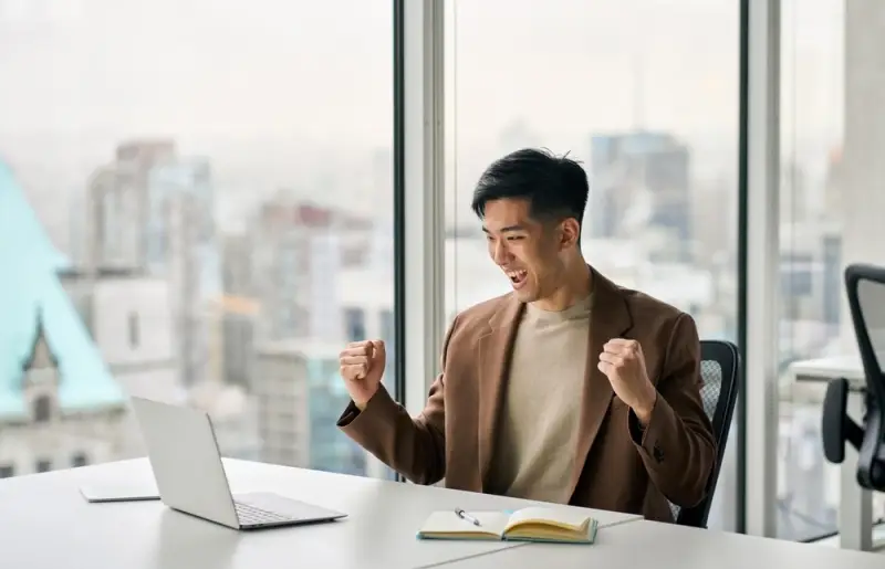 Asian man happy to see loan approval