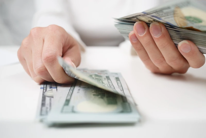 Female hands counting Legal Funding money