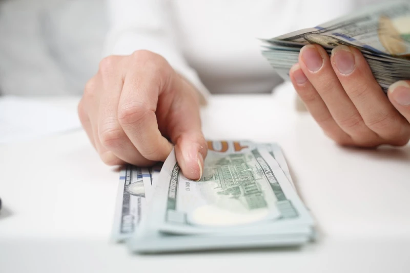 Female hands counting Legal Funding money
