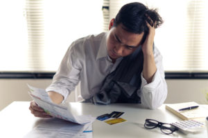 guy stressing over paperwork