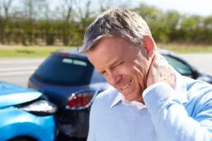 man holding his neck after an accident