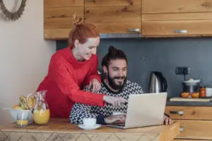 happy smiling couple paying bills online