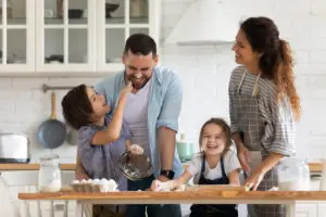 young family having fun baking at home