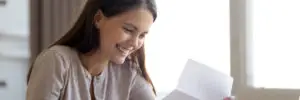 woman happy reading loan docs