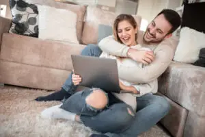 young couple excited over good financial news