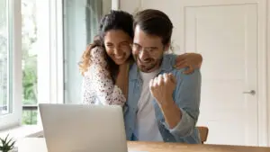 couple hugging happy to get funding