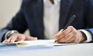 man-signing-loan-documents