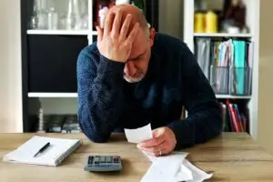man struggling over debt