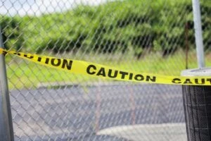 caution tape over a fence