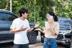 asian man and asian woman calling for help after a crash