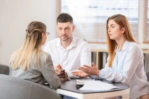 A couple discusses the divorce process with a lawyer in Georgia. Consult with a family law attorney who can explain what you need to end your marriage legally, including residency requirements to custody and property division.