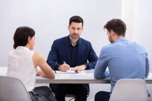 An lawyer listens to a couple during a mediation session in Georgia. When is divorce mediation not recommended?