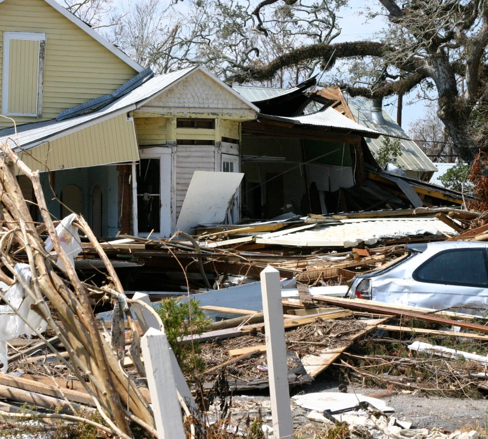 Wrecked house and car due to a hurricane.