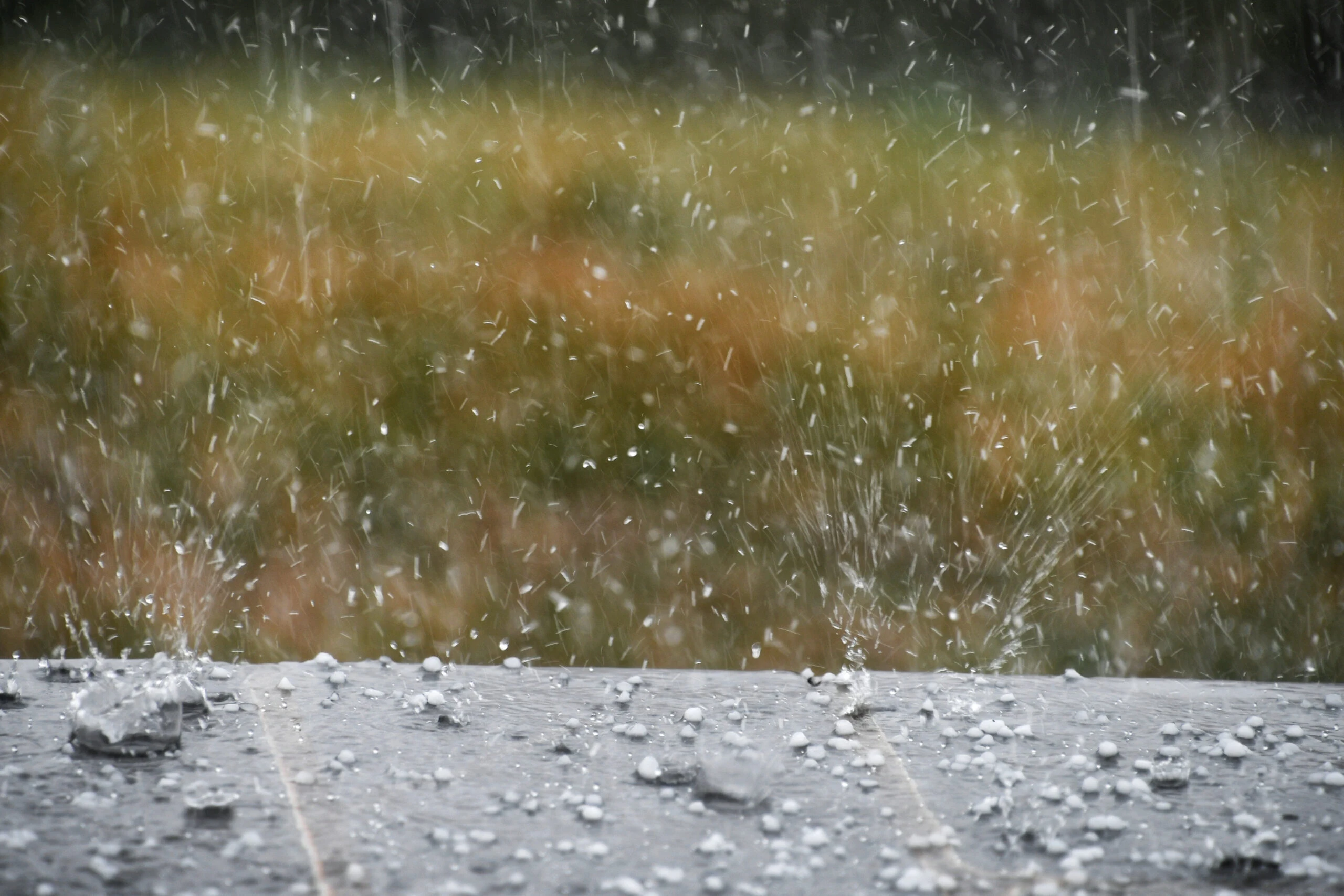Close-up of hails splattering on the patio.