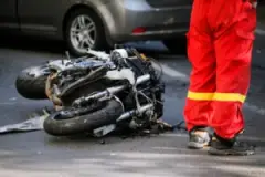 EMT-standing-next-to-a-wrecked-motorcycle-after-a-collision