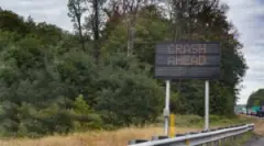 Crash Ahead Sign By An Interstate