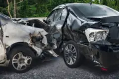 Two Severely Damaged Cars Following An Interstate Accident
