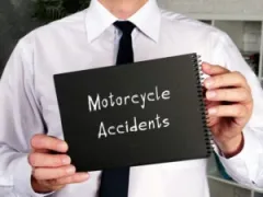 lawyer-holding-motorcycle-accident-sign