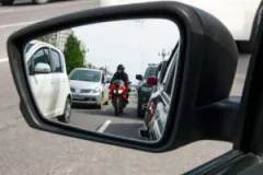 motorcycle-in-car’s-side-mirror