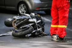 The photo depicts the accident scene of a motorcycle crash and people discuss what to do after a motorcycle accident.