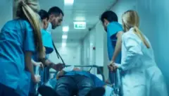 Nurses rush a patient to the emergency room after a catastrophic injury accident.