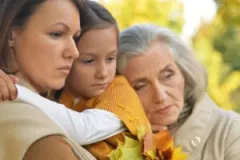 Three women grieve the loss of a loved one