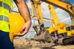construction-worker-in-front-of-excavator