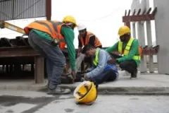 Construction workers after an accident. Find out if you can get help from a construction accident lawyer if you partially caused the accident.