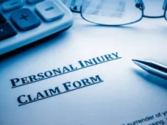 A calculator and a personal injury claim form.