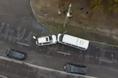 An overhead view of a head-on collision between a passenger car and a small truck.
