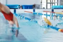 Lifeguard preventing drowning accidents in a pool. A drowning accident attorney in Muncie can help you seek compensation after a drowning accident.