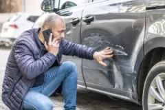 The owner of a damaged vehicle calls a parking lot accident lawyer to ask if he can sue after being hit by a car in the parking lot.